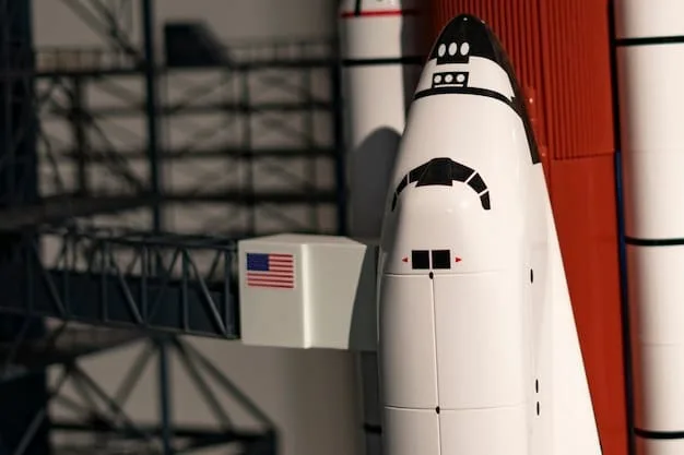 A close-up shot of the Orion spacecraft attached to the Space Launch System (SLS) on a launchpad, emphasizing the rocket's massive size and advanced engineering.