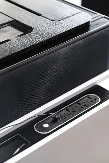 A close-up view of a high-end home theater speaker, showcasing its design and technology. The speaker is part of a surround sound system and is designed to deliver clear and immersive audio.