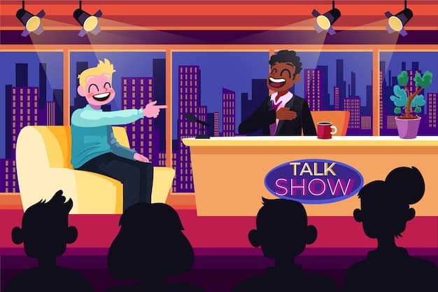 A comedian performing on a brightly lit stage with a large screen behind him displaying humorous graphics and animations related to his jokes. The audience is fully engaged and laughing.