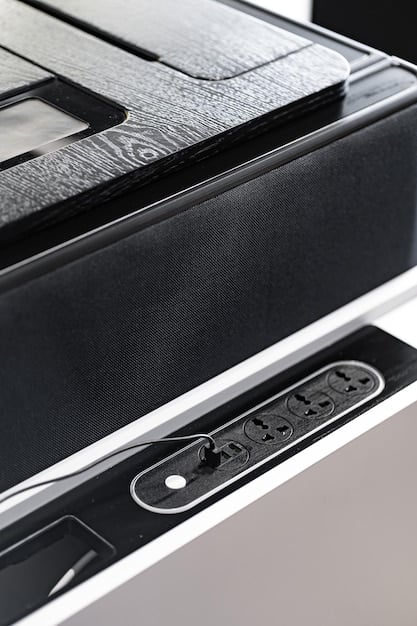 A close-up view of a high-end home theater speaker, showcasing its design and technology. The speaker is part of a surround sound system and is designed to deliver clear and immersive audio.