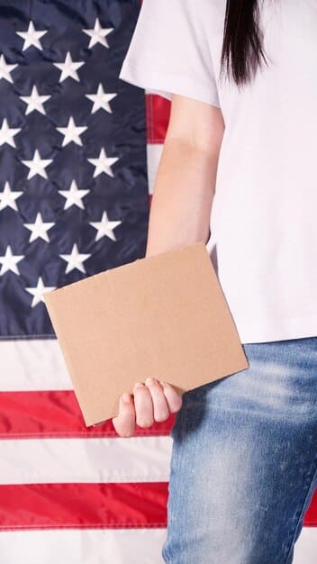 A close-up photograph of a ballot box with an American flag sticker on it, surrounded by hands of different skin tones casting their votes. The focus is on the act of voting as a civic duty.
